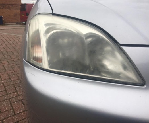 Headlight in need of lens restoration, Bishops Stortford, Hertfordshire